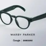Dark green round eyeglasses on a light background with branding text below (Warby Parker, Google, Samsung).