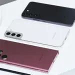 Four Samsung Galaxy phones in black, white, burgundy, and pink arranged diagonally on a white surface, with an S Pen in the foreground.