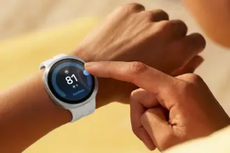 Close-up of a white smartwatch on the wrist, finger tapping the screen showing a health score of 81 and 'Excellent'.