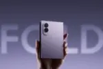 A hand holding a foldable smartphone with a dual-camera module on the back.